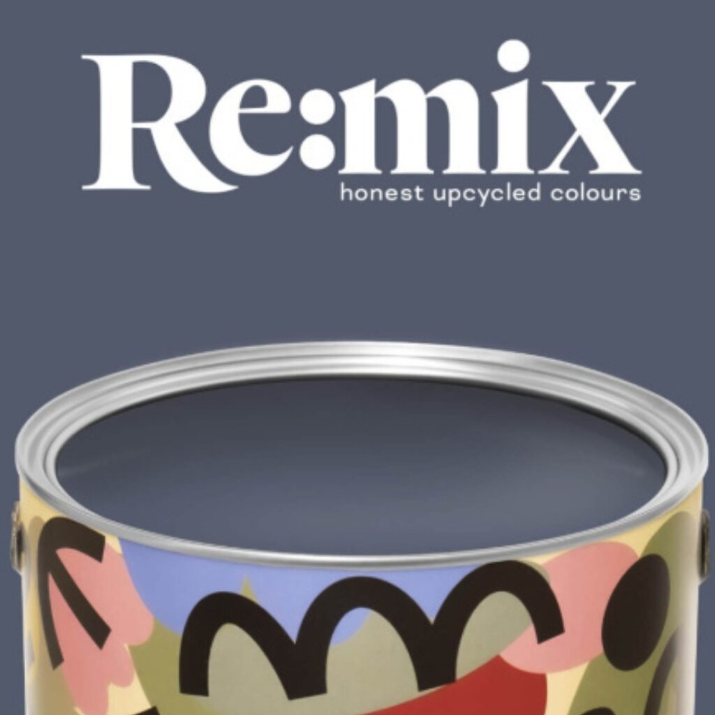 A paint tin with a colourful, abstract design sits below the words “Re:mix honest upcycled colours” on a muted blue-grey background.